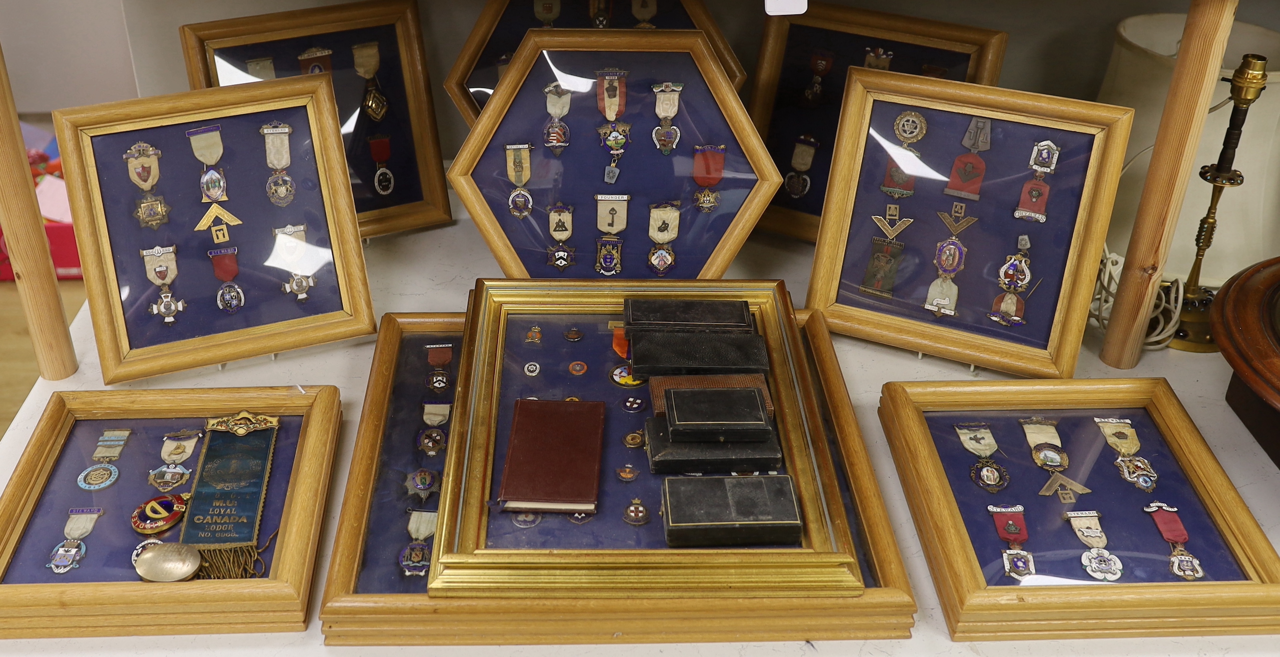 A collection of 20th century enamelled silver gilt or gilt metal Masonic medals with ribbons and clasps, approx. 47 in silver, and similar badges (mounted in 10 cases)